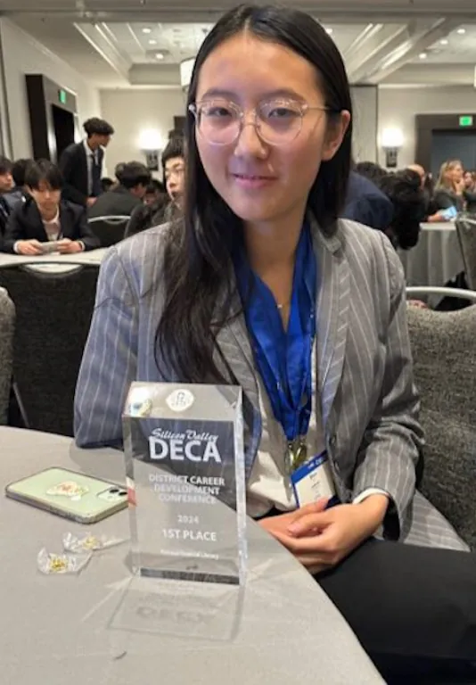 Erika Wu with her first-place DECA district trophy